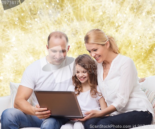 Image of smiling family with laptop