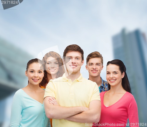 Image of group of smiling teenagers over city background