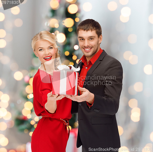 Image of smiling man and woman with present