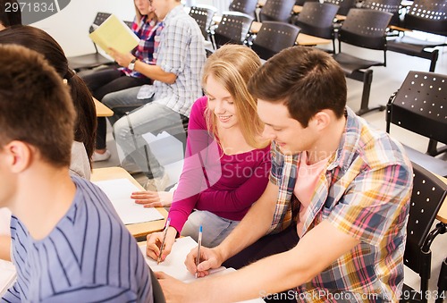 Image of group of smiling students in lecture hall