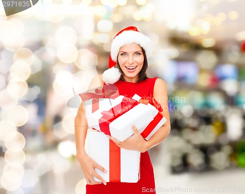 Image of smiling woman in red dress with gift boxes