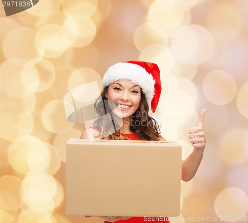 Image of smiling woman in santa helper hat with parcel box