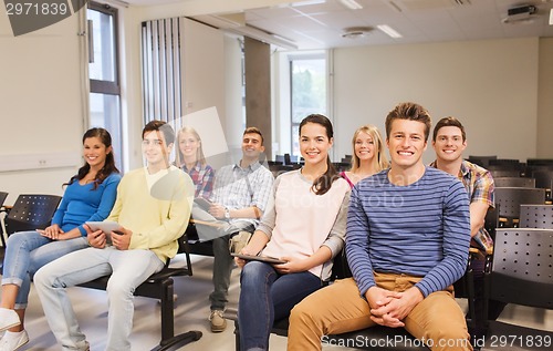 Image of group of smiling students with tablet pc
