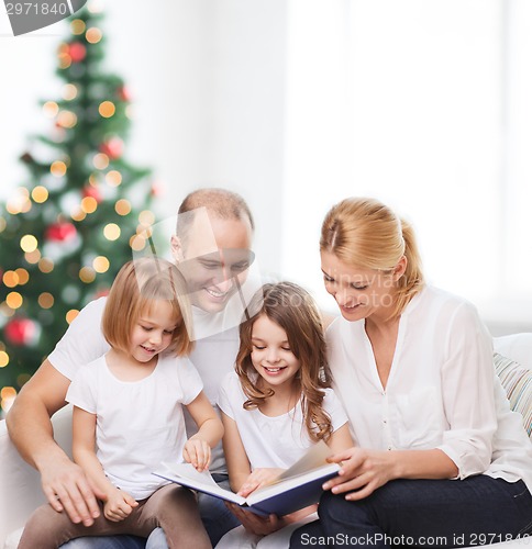 Image of happy family with book at home