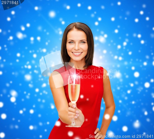 Image of smiling woman holding glass of sparkling wine