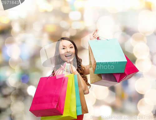 Image of smiling woman with colorful shopping bags