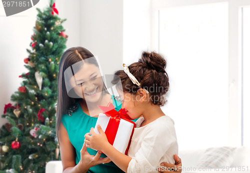 Image of happy mother and little girl with gift box