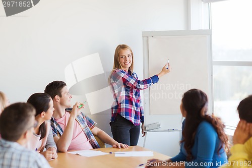 Image of group of smiling students with white board
