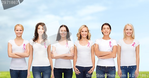 Image of smiling women with pink cancer awareness ribbons