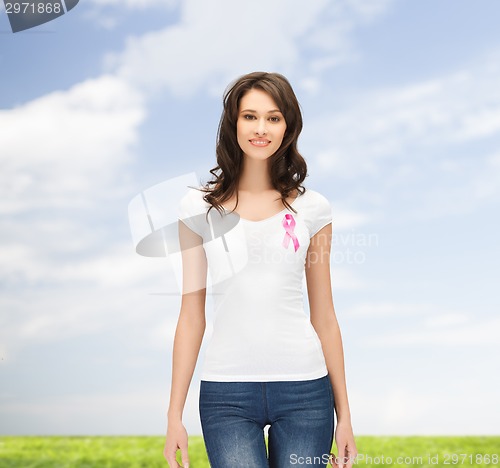 Image of smiling young woman with cancer awareness ribbon