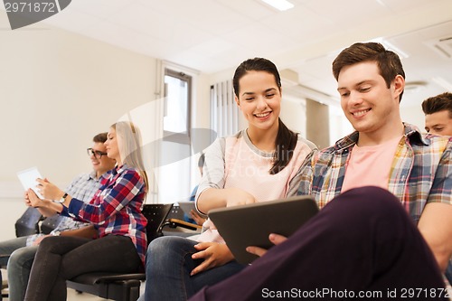 Image of group of smiling students with tablet pc