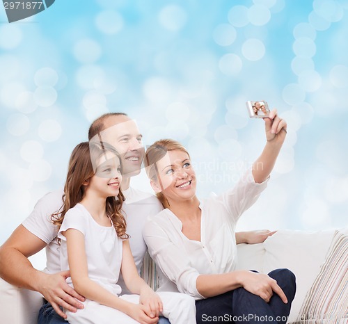 Image of happy family with camera at home