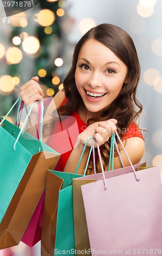 Image of smiling woman with colorful shopping bags