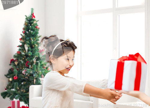 Image of smiling little girl with gift box