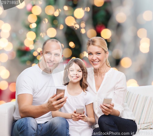 Image of happy family with smartphones