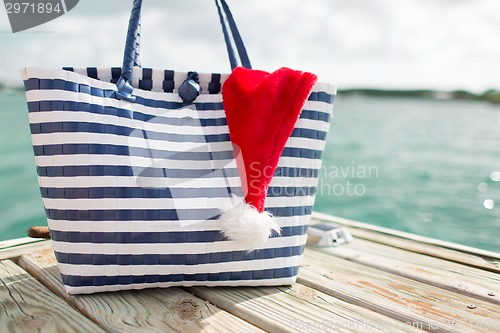 Image of close up of beach bag and santa helper hat