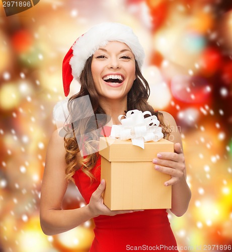 Image of smiling woman in santa helper hat with gift box