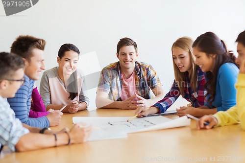 Image of group of smiling students with blueprint