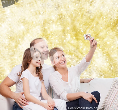 Image of happy family with camera at home