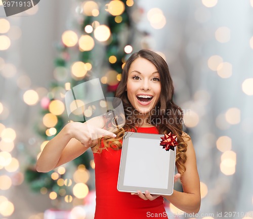 Image of smiling woman in red dress with tablet pc