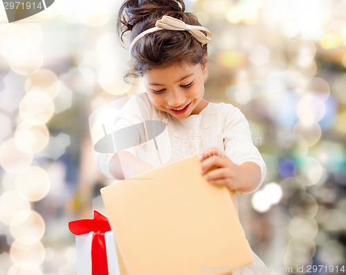 Image of smiling little girl with gift box