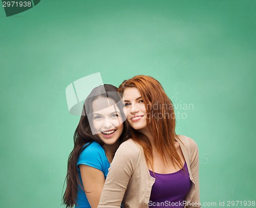 Image of smiling teenage girls hugging