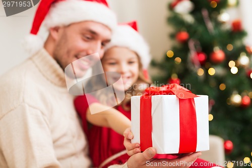 Image of close up of father and daughter with gift box