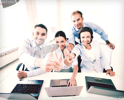 Image of group of office workers showing thumbs up