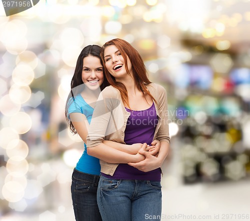 Image of smiling teenage girls hugging