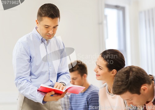 Image of group of students and teacher with notebook