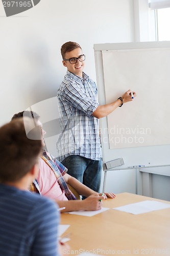 Image of group of smiling students with white board