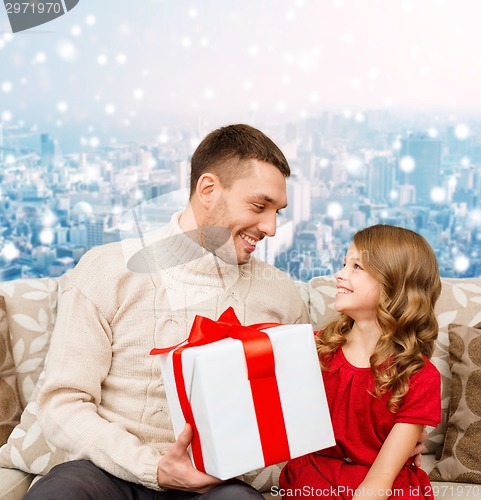 Image of smiling father and daughter with gift box