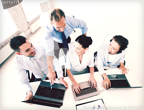 Image of group of people working in call center