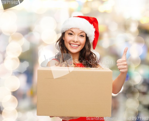 Image of smiling woman in santa helper hat with parcel box