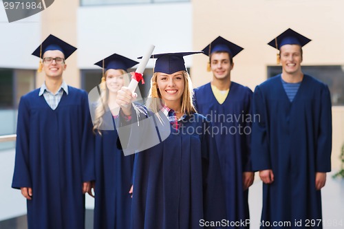 Image of group of smiling students in mortarboards