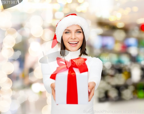 Image of smiling woman in santa helper hat with gift box