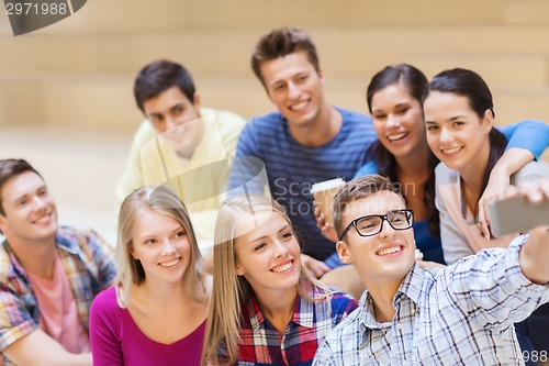 Image of group of students with smartphone and coffee cup