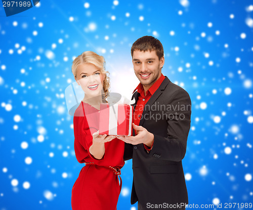 Image of smiling man and woman with present