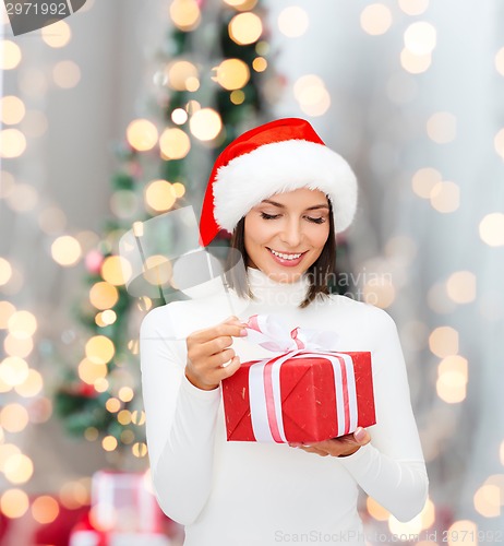 Image of smiling woman in santa helper hat with gift box