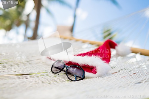 Image of hammock with santa helper hat and shades