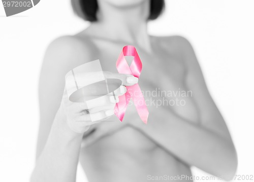 Image of hand holding pink breast cancer awareness ribbon