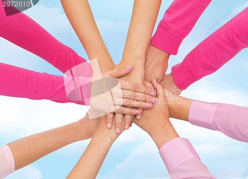 Image of close up of women with hands on top