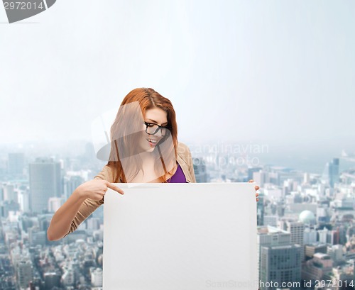 Image of smiling teenage girl in glasses with white board