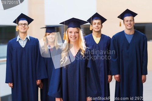 Image of group of smiling students in mortarboards