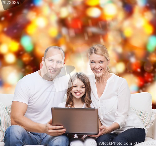 Image of smiling family with laptop