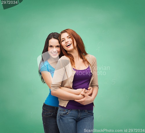 Image of smiling teenage girls hugging