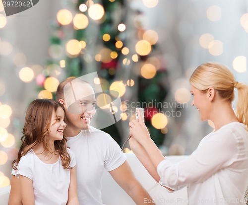 Image of happy family with camera at home