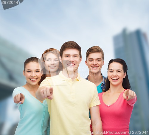 Image of group of smiling teenagers over city background