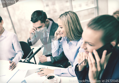 Image of business team with smartphones having conversation