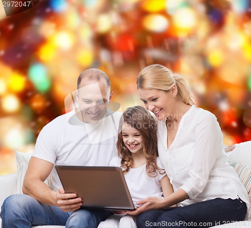 Image of smiling family with laptop